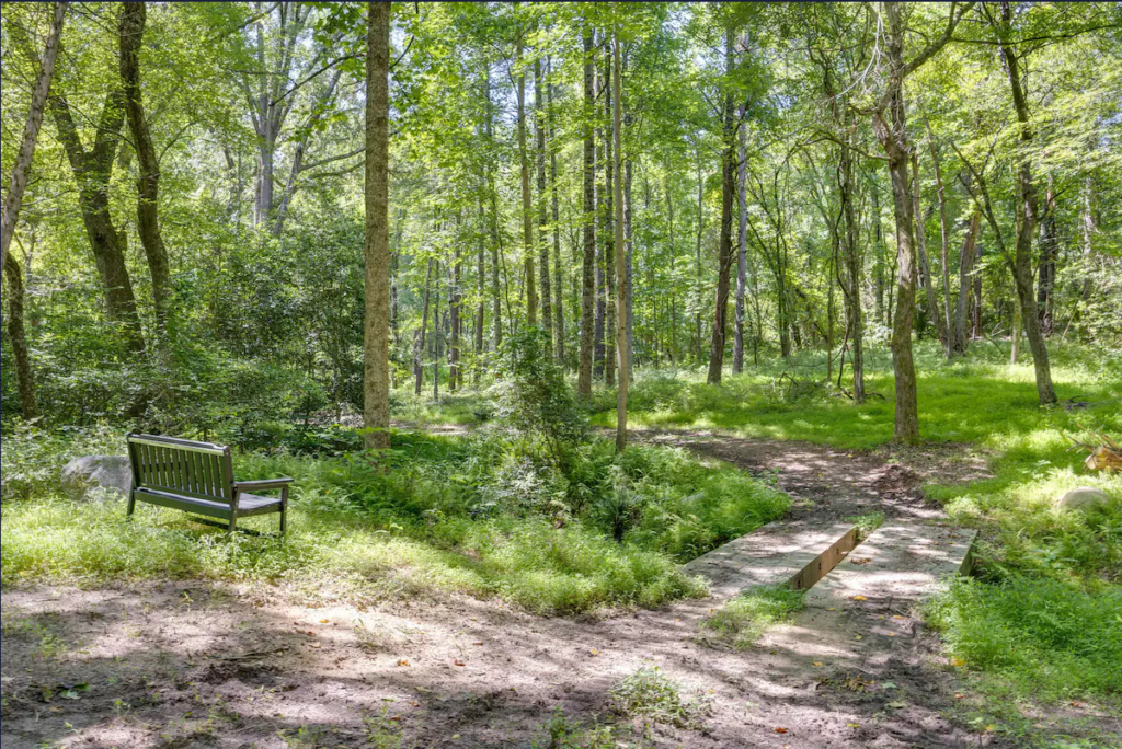 Bench by stream overlooking woods at Terre Haute Retreat Center, Virginia.